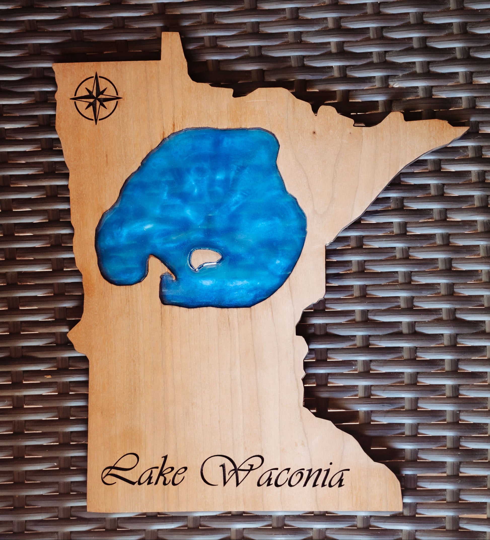 A wooden wall art plaque shaped like the state of Minnesota, featuring a blue resin inlay representing Lake Wisconsin and the words 'Lake Wisconsin' engraved at the bottom