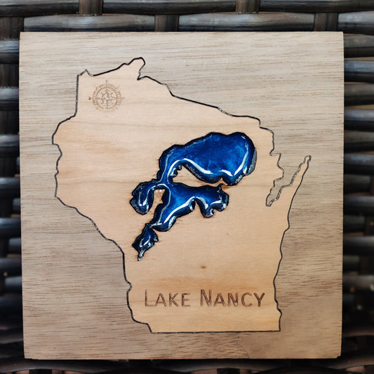 A square wooden plaque featuring a map outline of Wisconsin with a blue Lake Michigan graphic and the text 'LAKE NANCY' at the bottom